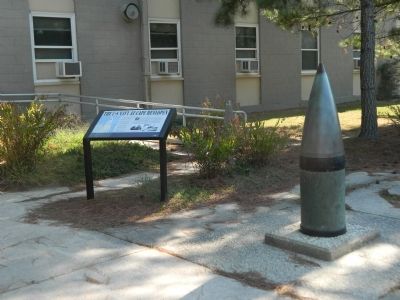 Marker next to 16-inch artillery shell in front of Biden Center image, Touch for more information