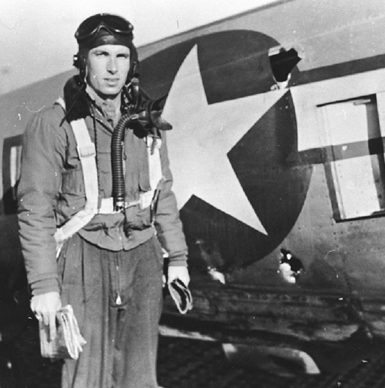 1Lt. Raymond L. Knight showing combat damage from a mission he had just flown image. Click for full size.