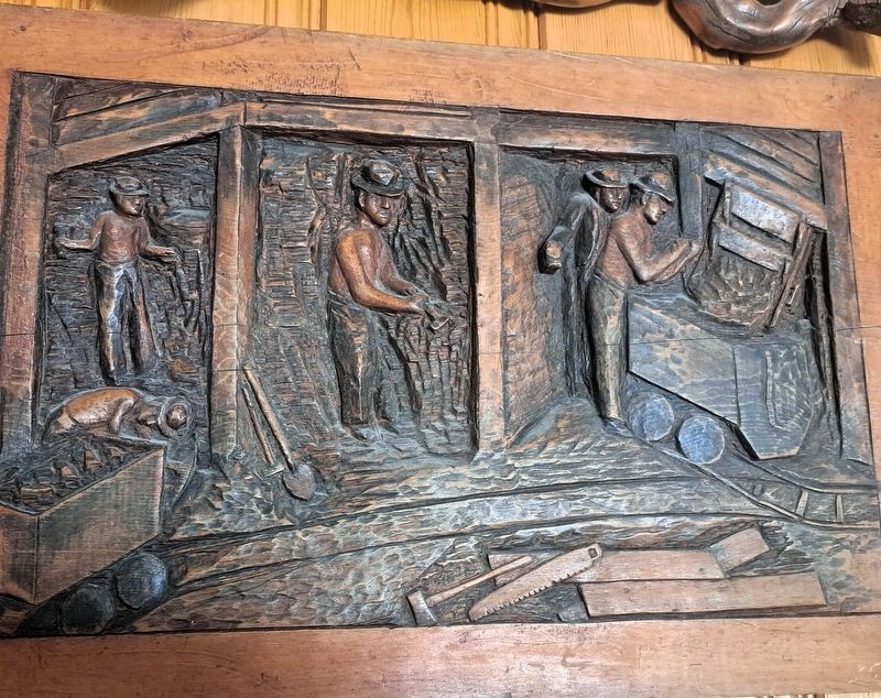 Historical relief carving of underground Comstock Miners. Click for full size. Historical relief carving of underground Comstock Miners image. Click for full size.